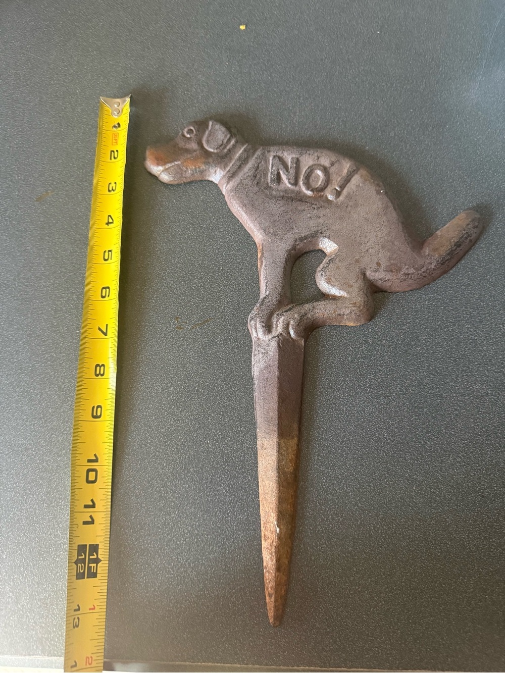 cast iron "No Pooping" dog yard sign with an antique rust finish.